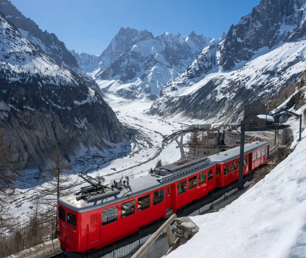 Montenvers train (cogwheel train) with Les Grandes Jorasses peaks and Mer de Glace glacier. View of Vallee Blanche (winter ski resort) of the Mont Blanc massif, Alps, Haute-Savoie, France