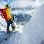 skier standing on top, snow, sunny day