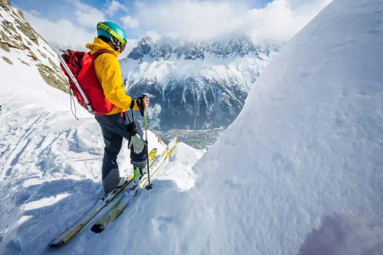 skier standing on top, snow, sunny day