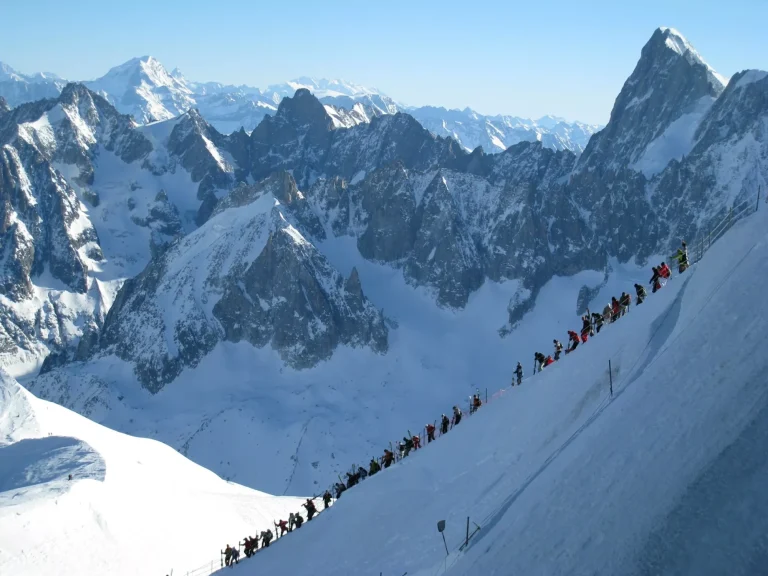 Skiers descending mountain ridge above Chamonix